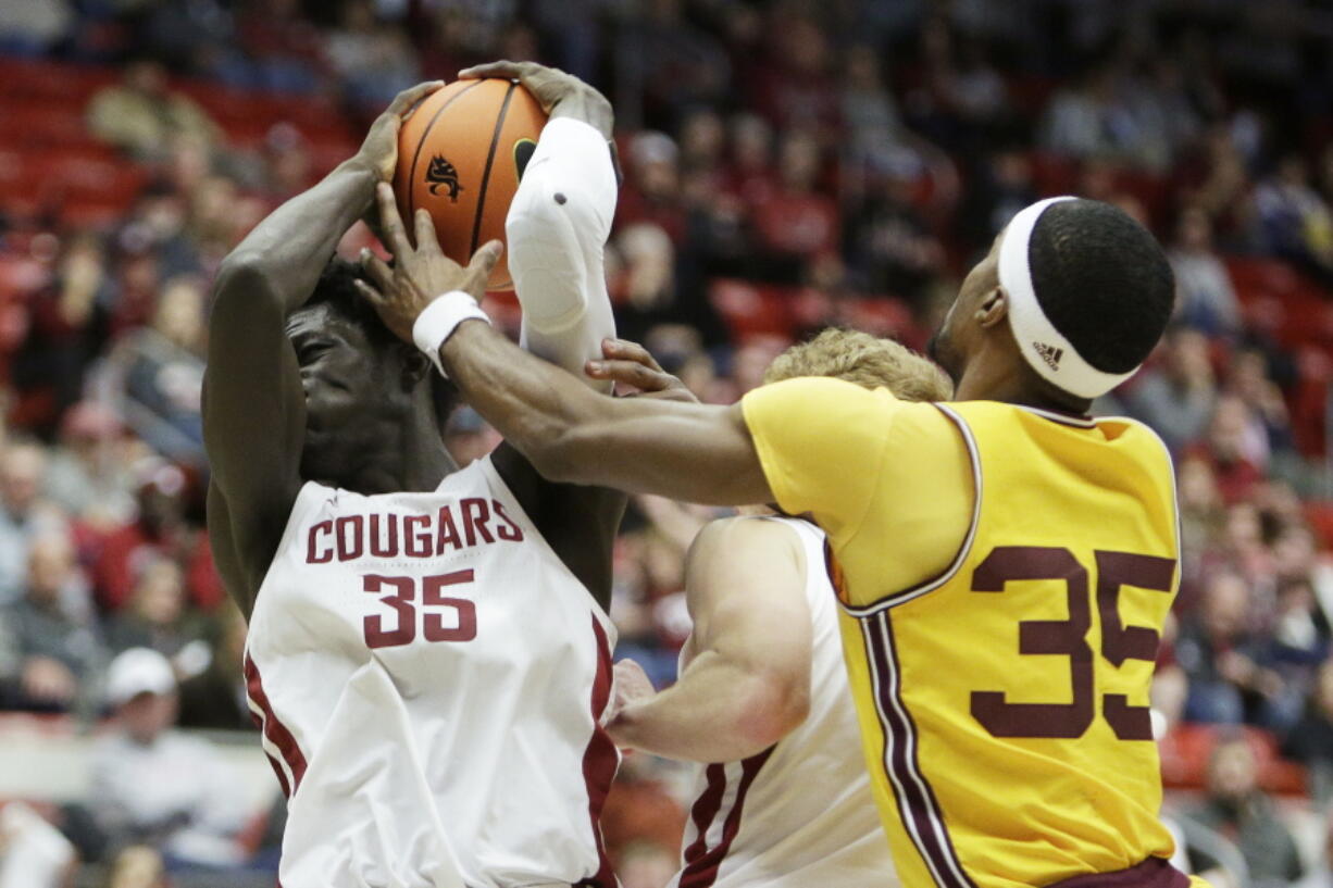 Washington State forward Mouhamed Gueye, left, grabs a rebound next to Arizona State guard Devan Cambridge during the second half of an NCAA college basketball game, Saturday, Jan. 28, 2023, in Pullman, Wash.