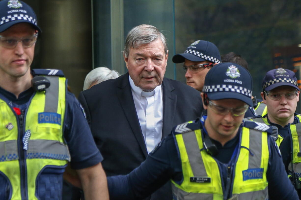 FILE - Cardinal George Pell, center, the most senior Catholic cleric to face sex charges, leaves court in Melbourne, Australia, May 2, 2018. Pell, who was the most senior Catholic cleric to be convicted of child sex abuse before his convictions were later overturned, has died Tuesday, Jan. 10, 2023, in Rome at age 81.