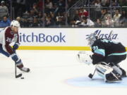 Colorado Avalanche center Nathan MacKinnon (29) prepares to shoot on Seattle Kraken goaltender Philipp Grubauer (31) for the only goal of the shootout in an NHL hockey game Saturday, Jan. 21, 2023, in Seattle. The Avalanche won 2-1.