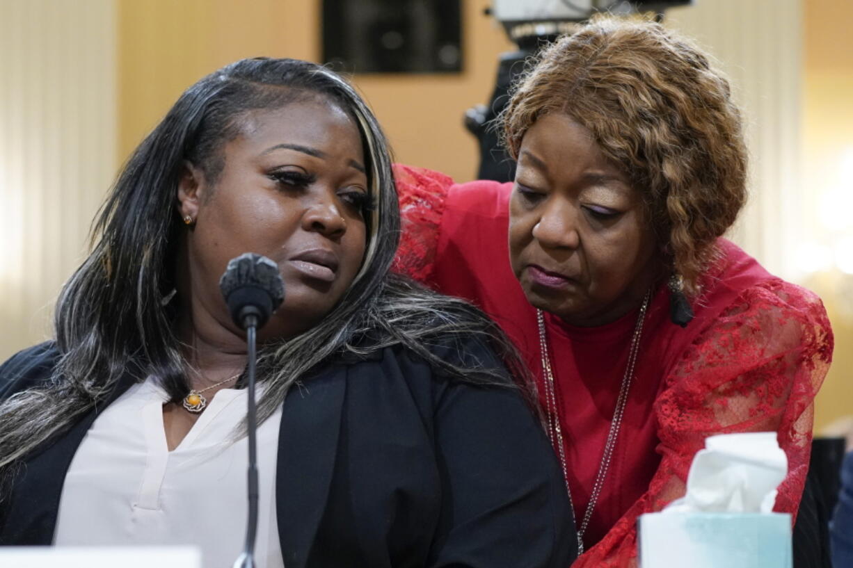 FILE - Wandrea "Shaye" Moss, a former Georgia election worker, is comforted by her mother Ruby Freeman, right, as the House select committee investigating the Jan. 6 attack on the U.S. Capitol continues to reveal its findings of a year-long investigation, at the Capitol in Washington, June 21, 2022. President Joe Biden on Friday, Jan. 6, 2023, will present the nation's second highest civilian to 12 individuals involved in defending the Capitol during the insurrection on Jan. 6, 2021, and safeguarding the will of American voters in the 2020 presidential election, including Moss and Freeman.