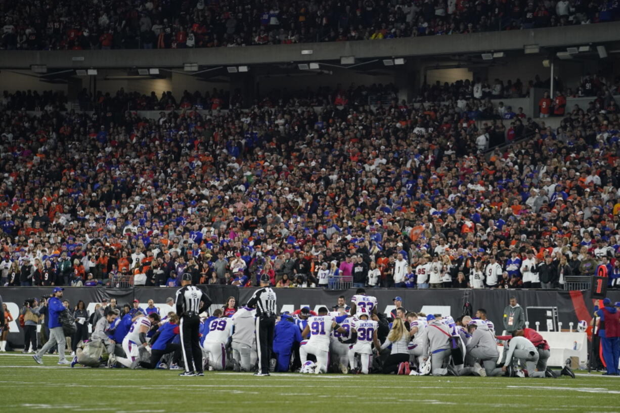 The Buffalo Bills players pray for teammate Damar Hamlin during the first half of an NFL football game against the Cincinnati Bengals, Monday, Jan. 2, 2023, in Cincinnati.