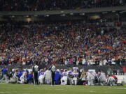 The Buffalo Bills players pray for teammate Damar Hamlin during the first half of an NFL football game against the Cincinnati Bengals, Monday, Jan. 2, 2023, in Cincinnati.