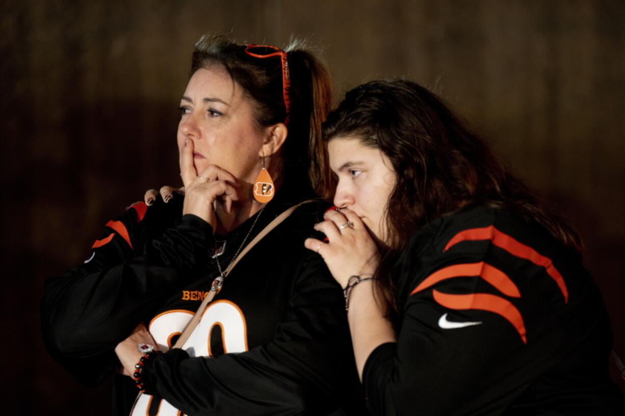 Heather Rohr, of Montfort Heights, and Anna Britt, of Groesbeck, stand outside the University of Cincinnati Medical Center where Buffalo Bills safety Damar Hamlin was taken after collapsing during an NFL football game against the Cincinnati Bengals in Cincinnati on Monday, Jan. 2, 2023.