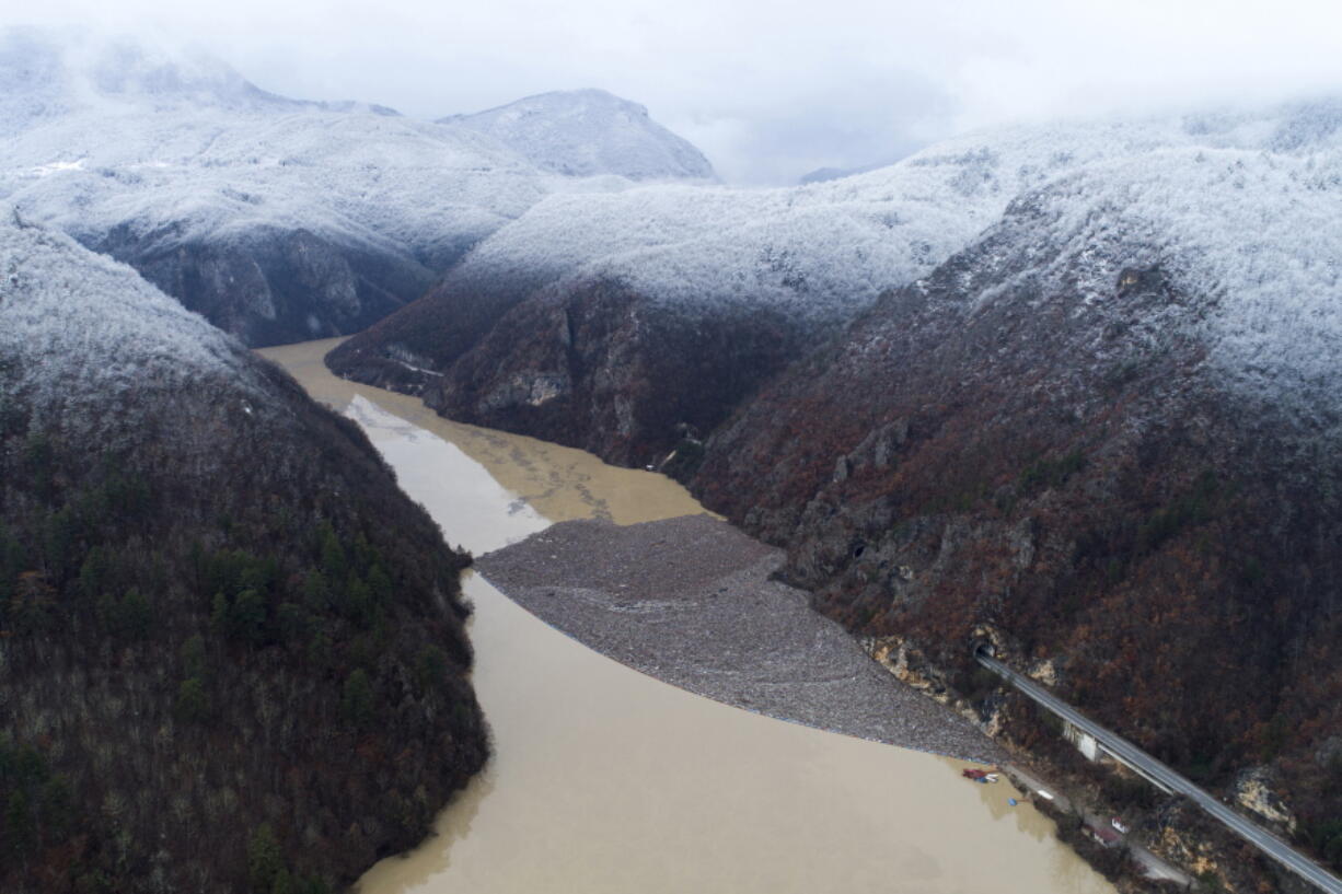 Aerial view of waste floating in the Drina river near Visegrad, Bosnia, Friday, Jan. 20, 2023. Tons of waste dumped in poorly regulated riverside landfills or directly into the rivers across three Western Balkan countries end up accumulating during high water season in winter and spring, behind a trash barrier in the Drina River in eastern Bosnia.