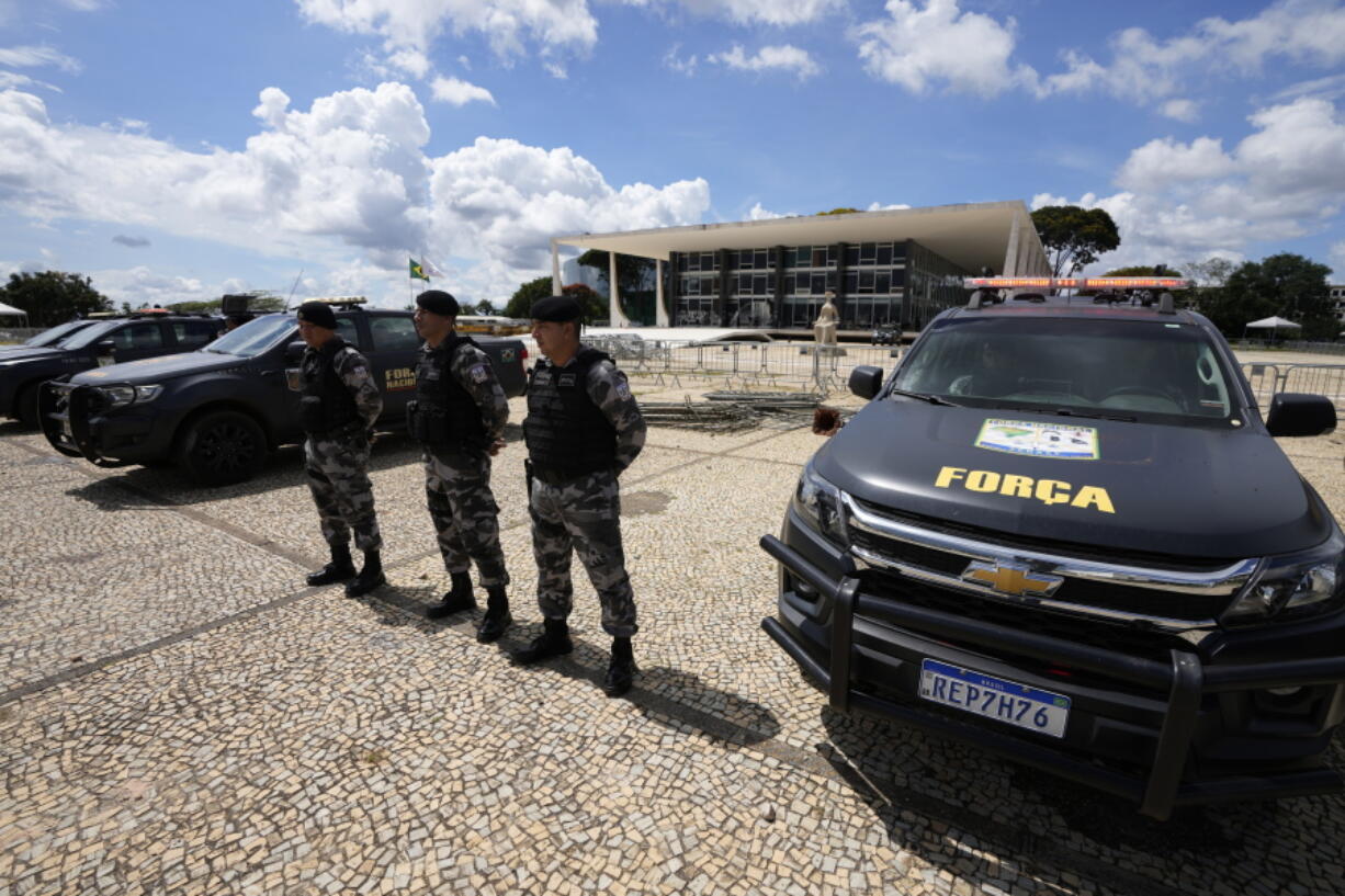 Military police stand guard outside the Supreme Court in Brasilia, Brazil, Wednesday, Jan. 11, 2023, ahead of expected protests called for by supporters of former Brazilian President Jair Bolsonaro.