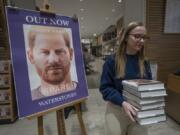 A member of staff places the copies of the new book by Prince Harry called "Spare" at a book store in London, Tuesday, Jan. 10, 2023. Prince Harry's memoir "Spare" went on sale in bookstores on Tuesday, providing a varied portrait of the Duke of Sussex and the royal family.