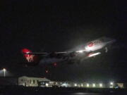 A repurposed Virgin Atlantic Boeing 747 aircraft, named Cosmic Girl, carrying Virgin Orbit's LauncherOne rocket, takes off from Spaceport Cornwall at Cornwall Airport, Newquay, England, Monday, Jan. 9, 2023. The plane will carry the rocket to 35,000 feet where it will be released over the Atlantic Ocean to the south of Ireland, as part of the Start Me Up mission and the first rocket launch from U.K. The rocket will take multiple small satellites, with a variety of civil and defence applications, into orbit.