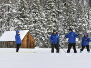 In this photo provided by the California Department of Water Resources, forecasting chief Sean de Guzman, second from right, and engineers work the measurement phase of the first media snow survey of the season at Phillips Station in the Sierra Nevada Mountains, Calif., Tuesday, Jan. 3, 2023. The snowpack in California's mountains is off to one of its best starts in 40 years, officials announced Tuesday, offering hope that the drought-stricken state could soon see relief in the spring when the snow melts and flows into reservoirs that provide water for drinking and farming.