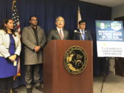 California Attorney General Rob Bonta, middle, speaks at a news conference in Sacramento, Calif., on Thursday, Jan. 12, 2023. Bonta announced a lawsuit accusing multiple companies that make or promote insulin of keeping prices too high.