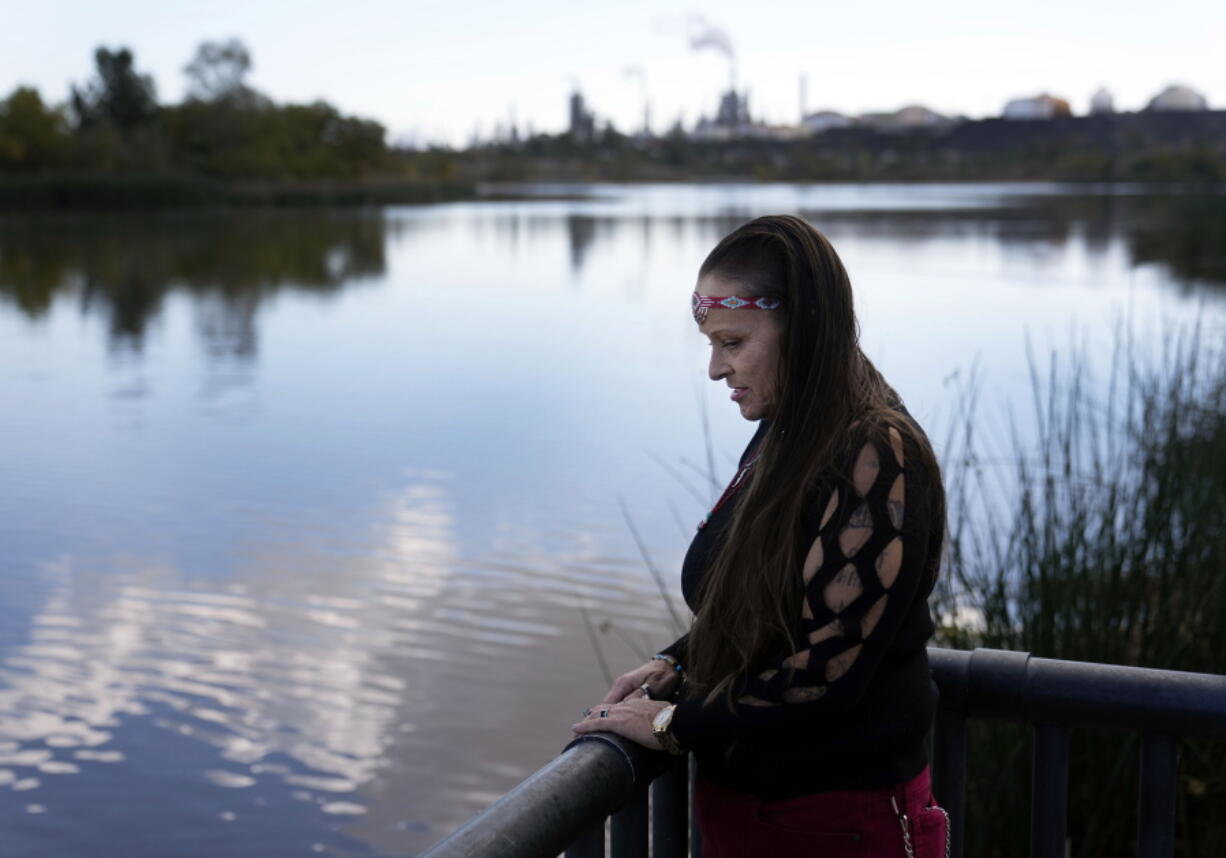 Moonlight Pulido stands by the shore at Harbor Lake Wednesday, Dec. 7, 2022, in Los Angeles. California is paying reparations to victims, mostly women, who were either forcibly or coercively sterilized by the government. Pulido was sterilized while incarcerated in 2005.