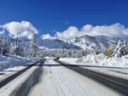 This Sunday, Jan. 1, 2023, photo released by Caltrans District 3, shows Sierra highway back open but chain controls remain in effect as crews clean up in South Lake Tahoe, Calif. California was drying out and digging out on New Year's Day after a powerful storm brought drenching rain or heavy snowfall to much of the state, snarling traffic and closing highways.