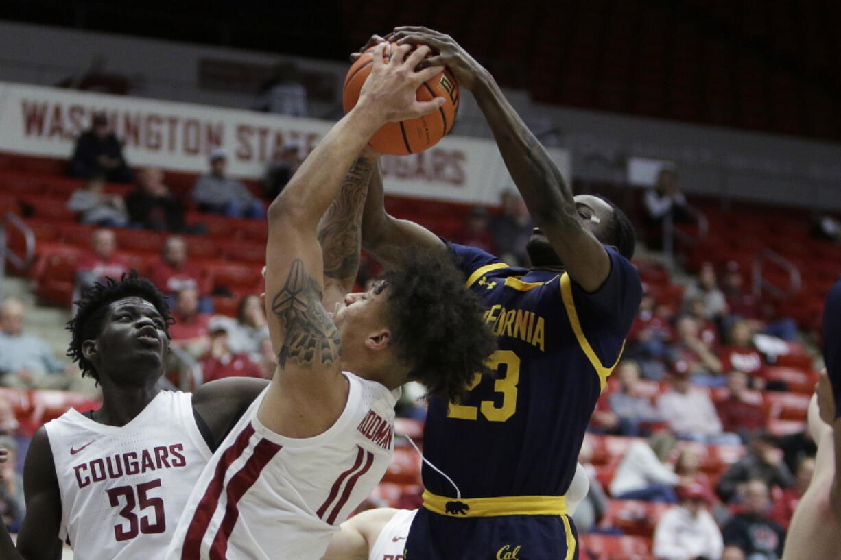 Washington State forward DJ Rodman (11) and California forward Obinna Anyanwu (23) go after a rebound during the second half of an NCAA college basketball game Wednesday, Jan. 11, 2023, in Pullman, Wash. Washington State won 66-51.