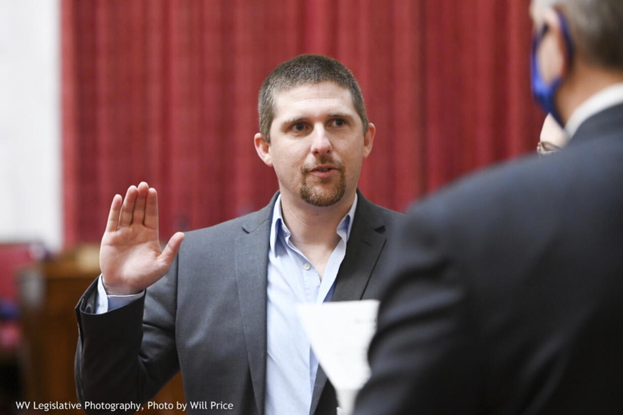 In this image provided by the West Virginia Legislative Photography, Derrick Evans is shown during his swearing-in ceremony to the West Virginia House of Delegates on Dec. 1, 2020, in Charleston, W.Va. Evans, a former West Virginia lawmaker who served three months in prison for his participation in the Jan. 6th Capitol riot, says he's running for Congress. Evans announced his plans Friday, Jan. 6, 2023, two years to the day after storming the U.S. Capitol.