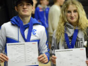Malachi Wallway and Leah Wallway pose with their brackets after becoming the third brother-sister duo to win Clark County championships in the same year at the Clark County Wrestling Championships at Union High School on Saturday, Jan.