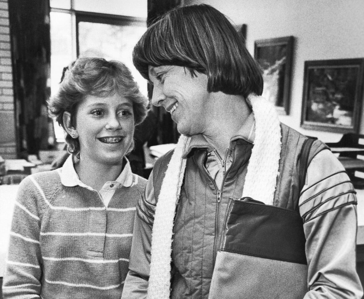 FILE - Kristin Preble, 13, and her mother Carol, get ready to leave the Ingomar Middle School in Franklin Park, Pa., Jan. 21, 1984. Kristin brought a briefcase with classified government documents to school as a show-and-tell project for her class. Her dad had found them in his Cleveland hotel room several years earlier and taken them home as a souvenir. Marked "Classified, Confidential, Executive" and "Property of the United States Government," the material from the Carter White House ended up in the hands of the Reagan campaign and, eventually, the schoolgirl. (AP Photo/Keith B.