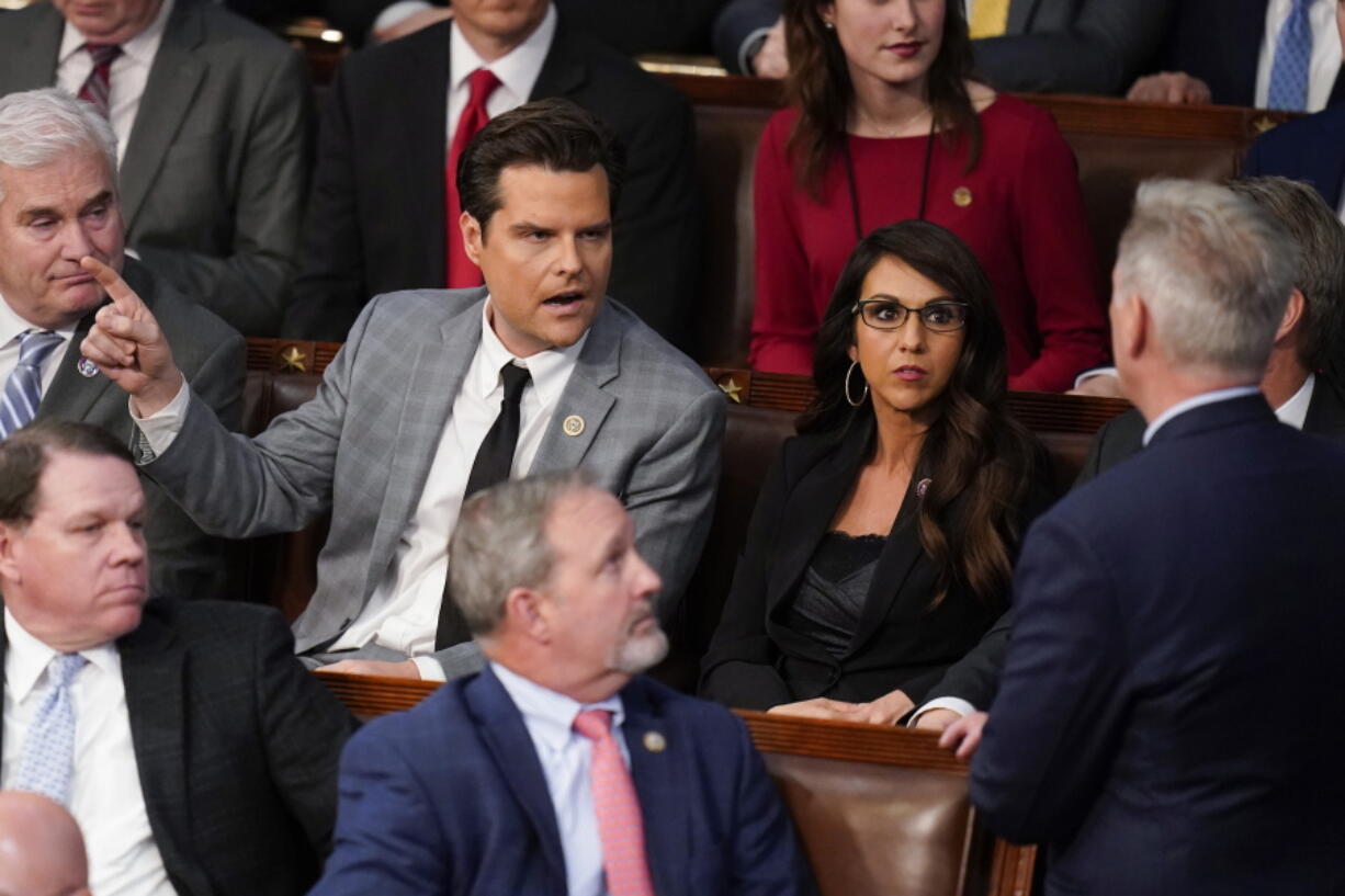 Rep. Matt Gaetz, R-Fla., talks to Rep. Kevin McCarthy, R-Calif., right, after Gaetz voted "present" in the House chamber as the House meets for the fourth day to elect a speaker and convene the 118th Congress in Washington, Friday, Jan. 6, 2023.