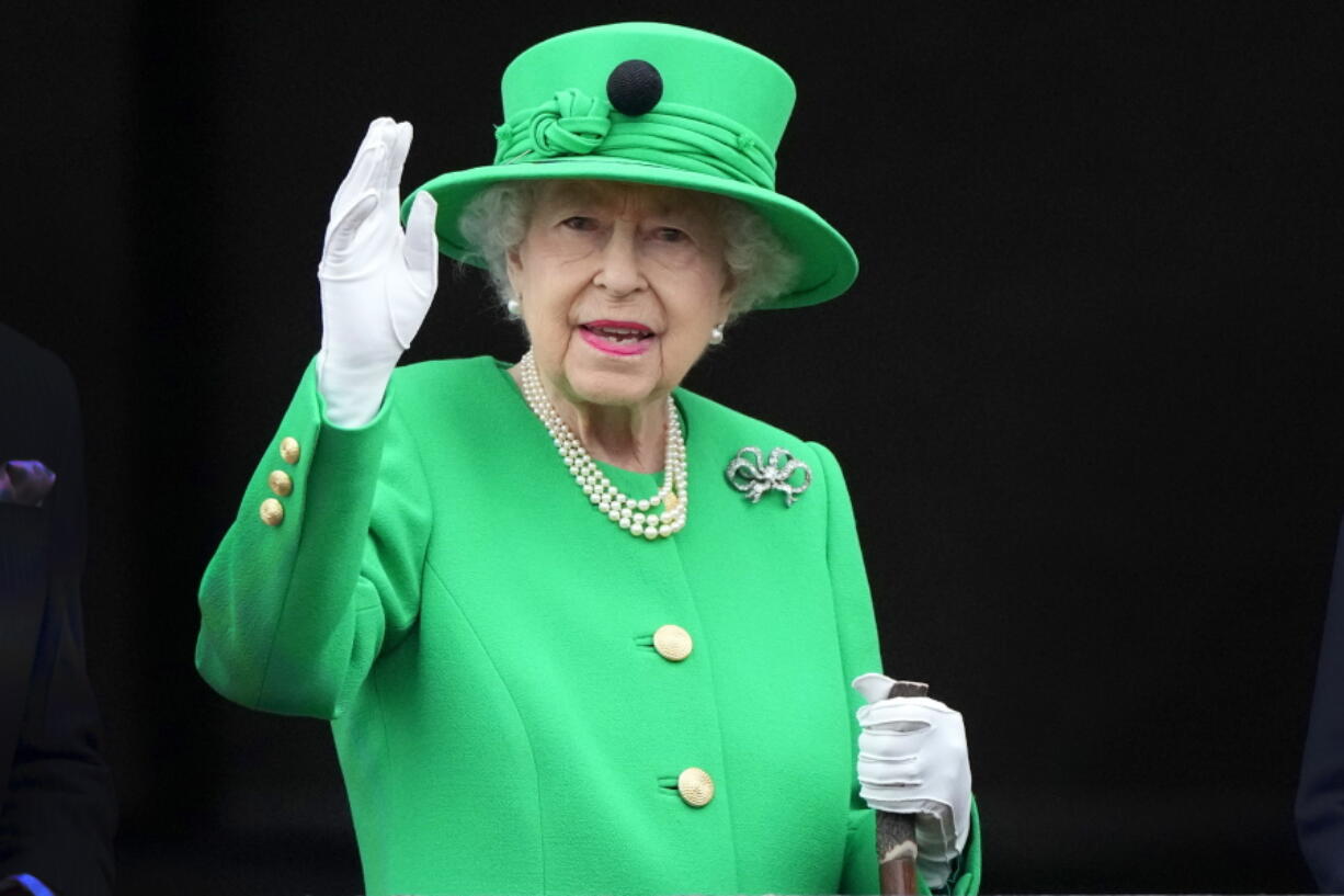 Britain's Queen Elizabeth II waves to the crowd during the Platinum Jubilee Pageant at the Buckingham Palace in London on June 5 on the last of four days of celebrations to mark the Platinum Jubilee.