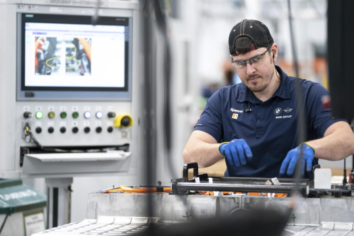 FILE - An employee works in the battery assembly hall at the BMW Spartanburg plant in Greer, S.C., Wednesday, October 19, 2022. On Thursday, the Commerce Department issues its first of three estimates of how the U.S.