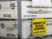 U.S. Postal Service bins are lined up to hold vote-by-mail ballots for scanning during the midterm election at the Miami-Dade County Elections Department, Nov. 8, 2022, in Miami. The U.S. Postal Service delivered more than 54 million ballots for the midterm election, with nearly 99% of ballots delivered to election officials within three days, officials said Monday, Jan. 9, 2023.