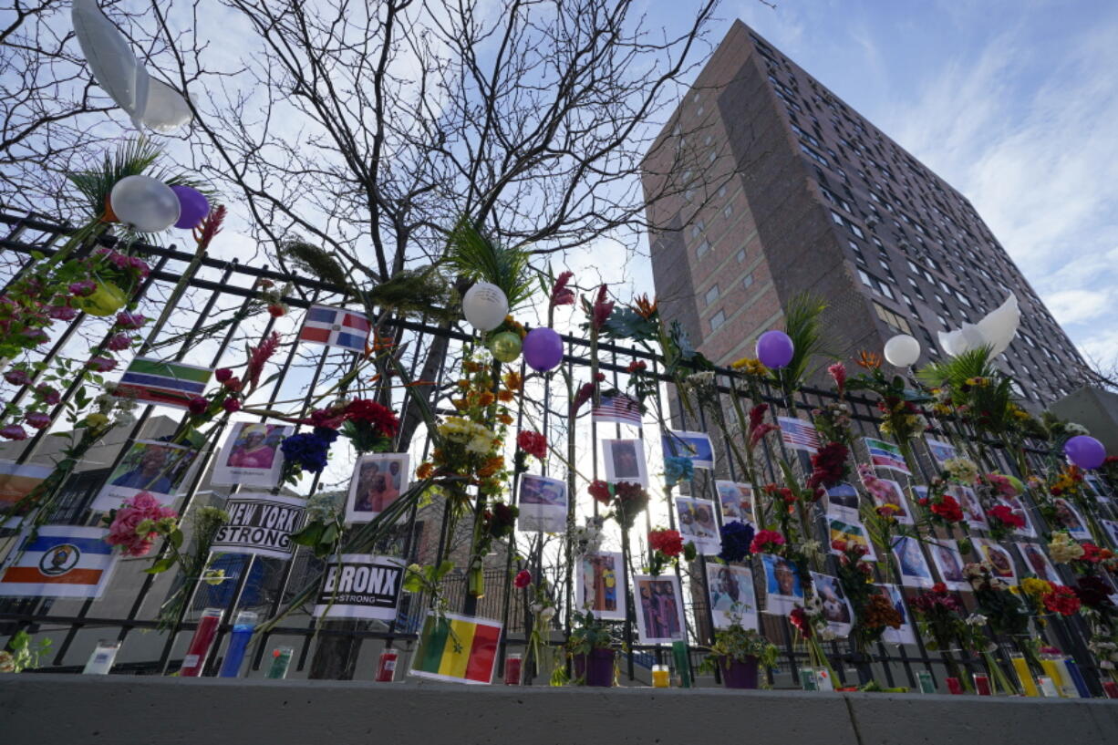 FILE - A memorial for the victims of an apartment building fire is displayed in front of the building in the Bronx borough of New York, Jan. 13, 2022. Fires feeding off modern materials found in people's homes are burning faster and becoming more deadly at the same time that fire departments across the country are struggling to retain and recruit firefighters, officials said Thursday, Jan. 12, 2023.