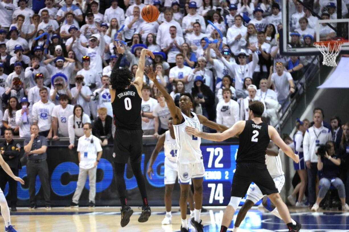 Gonzaga guard Julian Strawther (0) shoots a 3-pointer against BYU with about 10 seconds to go in an NCAA college basketball game Thursday, Jan. 12, 2023, in Provo, Utah.