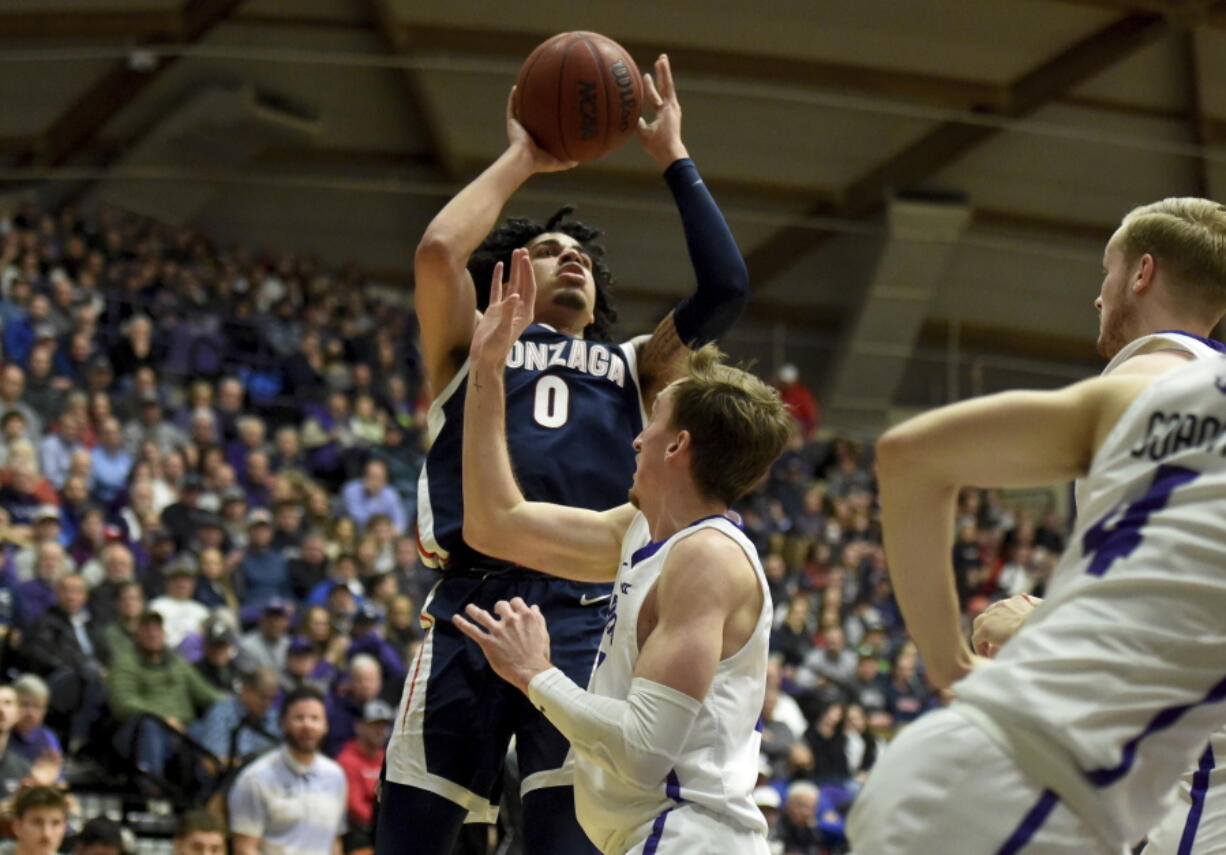 Gonzaga guard Julian Strawther, left, hits a shot over Portland forward Moses Wood, right, during the first half of an NCAA college basketball game in Portland, Ore., Saturday, Jan. 28, 2023.