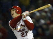 FILE - St. Louis Cardinals Scott Rolen watches his two-run home run off Houston Astros pitcher Chad Harville in the fifth inning during Game 2 of the National League Championship Series at Busch Stadium in St. Louis, Thursday, Oct. 14, 2004. Rolen could become just the 18th third baseman elected to baseball's Hall of Fame, the fewest of any position. Rolen, Todd Helton and Billy Wagner are the leading contenders in the Baseball Writers' Association of America vote announced Tuesday, Jan.