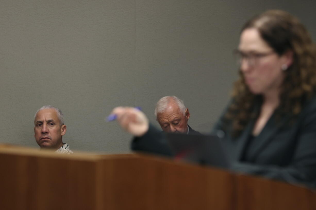 Albert "Ian" Schweitzer, left, looks on as Innocence Project attorney Susan Freidman speaks during Schweitzer's court case Tuesday, Jan. 24, 2023, in Hilo, Hawaii. Attorneys for Schweitzer, imprisoned for more than 20 years after his conviction for the 1991 sexual assault, kidnapping, and murder of a white woman visiting the Big Island, ask a judge Tuesday to dismiss his conviction due to new evidence, including DNA testing in the case.