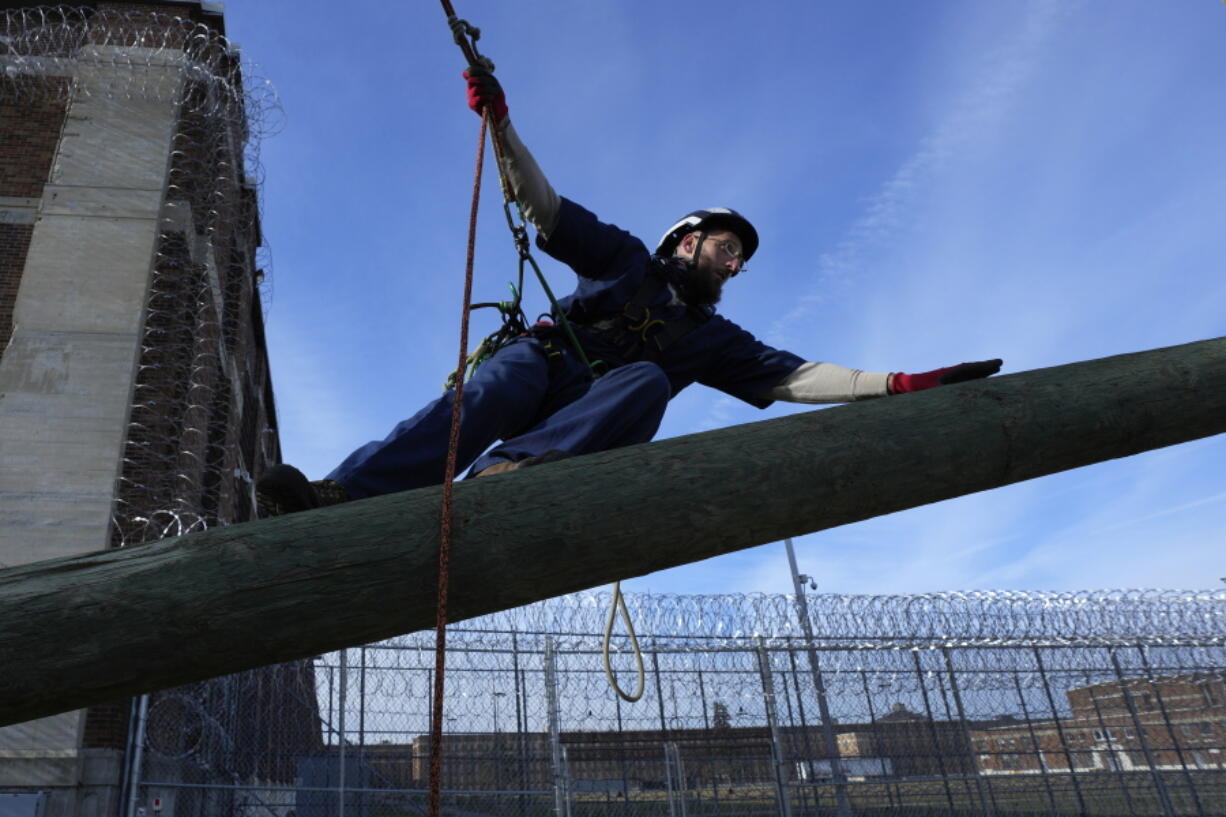 Prisoner Scott Steffes works on climbing at the Parnall Correctional Facility's Vocational Village in Jackson, Mich., Thursday, Dec. 1, 2022. Steffes, 37, whose release date is Jan. 17, 2023, is one of more than a dozen prisoners learning how to climb trees and trim branches around power lines as part of DTE Energy's plan to improve the utility's electric infrastructure.