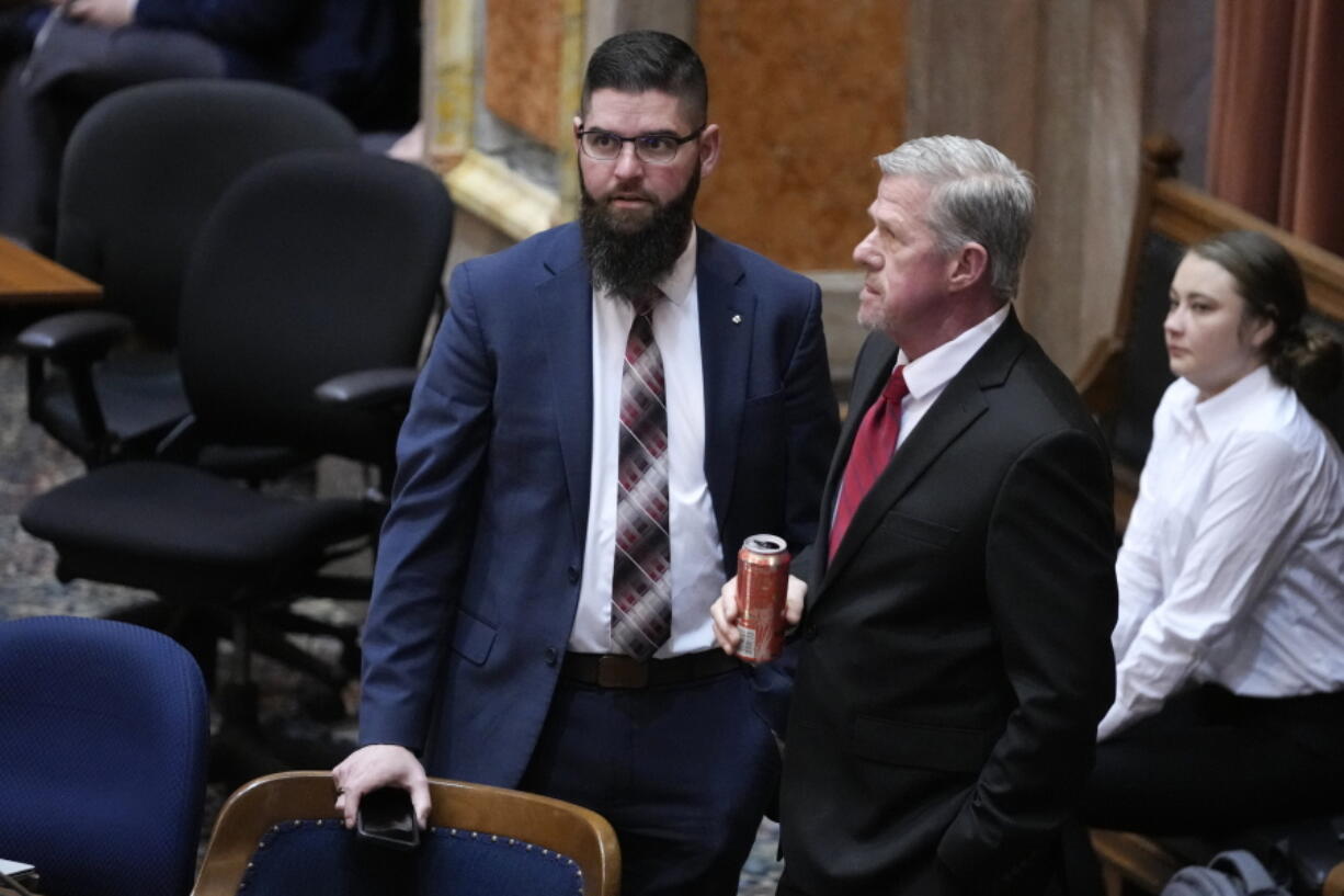 Iowa House Majority Leader Matt W. Windschitl, left, talks with State Sen. Brad Zaun, R-Polk, during debate on a bill that would create education savings accounts, Monday, Jan. 23, 2023, at the Statehouse in Des Moines, Iowa.