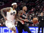 Portland Trail Blazers guard Damian Lillard, right, drives to the basket on Utah Jazz guard Jordan Clarkson, left, during the first half of an NBA basketball game in Portland, Ore., Wednesday, Jan. 25, 2023.