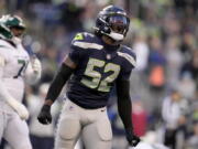 Seattle Seahawks defensive end Darrell Taylor (52) celebrates a defensive stop against the -n- during the second half of an NFL football game, Sunday, Jan. 1, 2023, in Seattle. (AP Photo/Godofredo A.