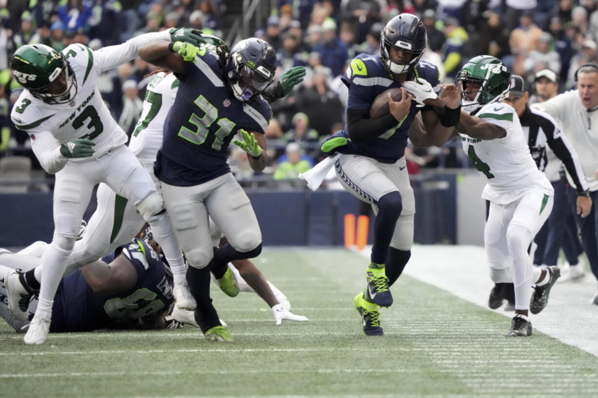 Seattle Seahawks safety Johnathan Abram (23) breaks up a pass intended for New York Jets wide receiver Corey Davis (84) during the second half of an NFL football game, Sunday, Jan. 1, 2023, in Seattle. (AP Photo/Godofredo A.