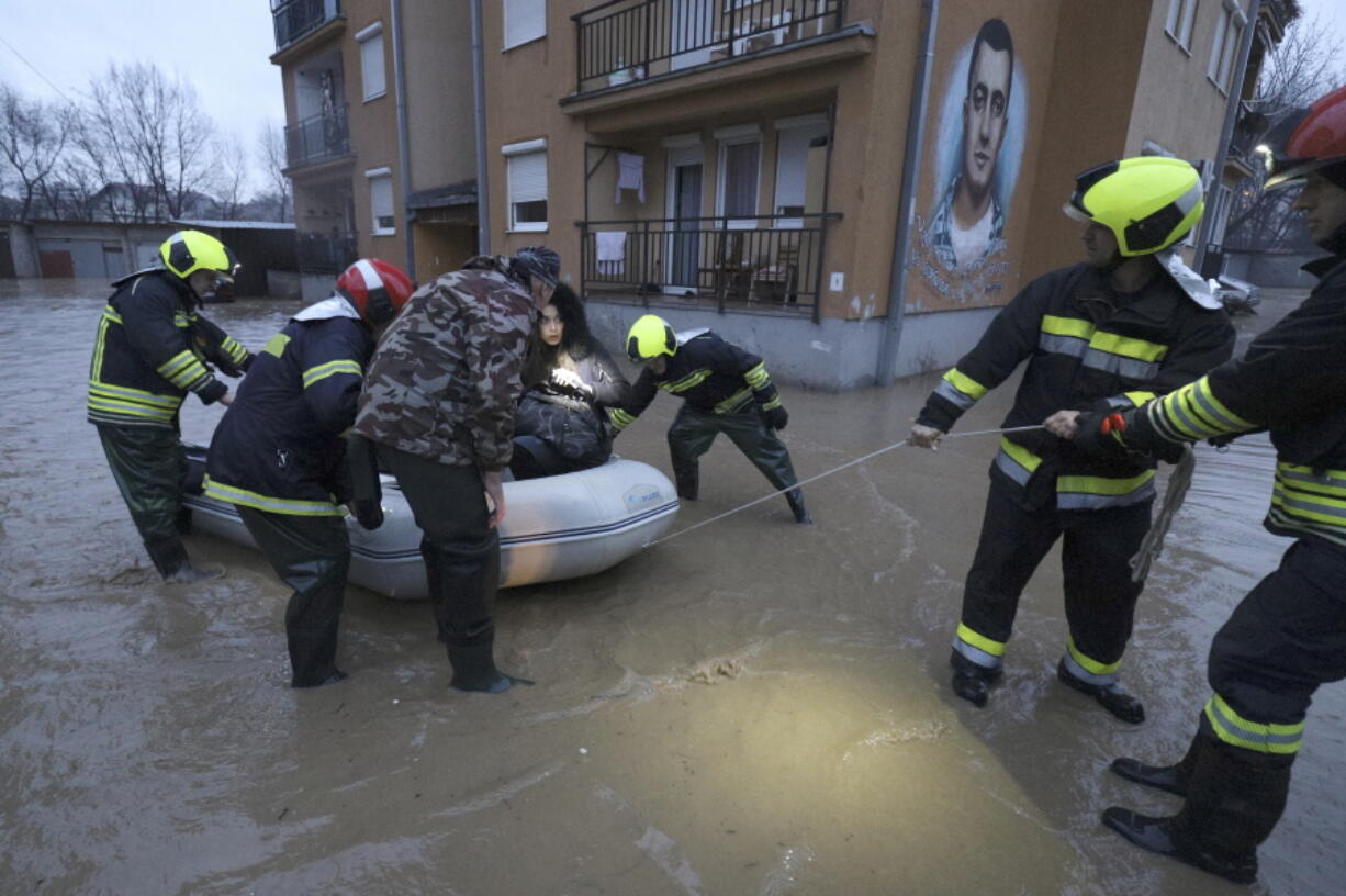 Firefighters evacuate people from a flooded area in northern Serb-dominated part of ethnically divided town of Mitrovica, Kosovo, Thursday, Jan. 19, 2023. Heavy rainfall this week across the Balkans has caused rivers to rise dangerously in Serbia, Bosnia, Kosovo and Montenegro, flooding some areas and threatening flood defenses elsewhere.