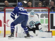 Seattle Kraken goaltender Martin Jones (30) stops Toronto Maple Leafs right wing William Nylander (88) during the first period of an NHL hockey game Thursday, Jan. 5, 2023, in Toronto.