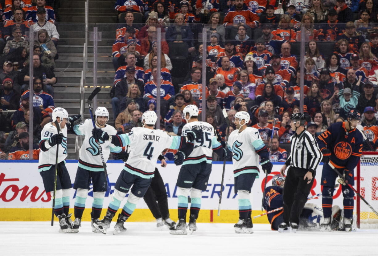 Seattle Kraken celebrate a goal against the Edmonton Oilers during the second period of an NHL hockey game, Tuesday, Jan. 3, 2023 in Edmonton, Alberta.