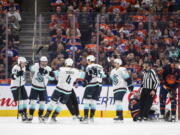 Seattle Kraken celebrate a goal against the Edmonton Oilers during the second period of an NHL hockey game, Tuesday, Jan. 3, 2023 in Edmonton, Alberta.