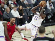 Los Angeles Lakers guard Patrick Beverley, right, shoots while being fouled by Portland Trail Blazers guard Damian Lillard during the second half of an NBA basketball game in Portland, Ore., Sunday, Jan. 22, 2023.