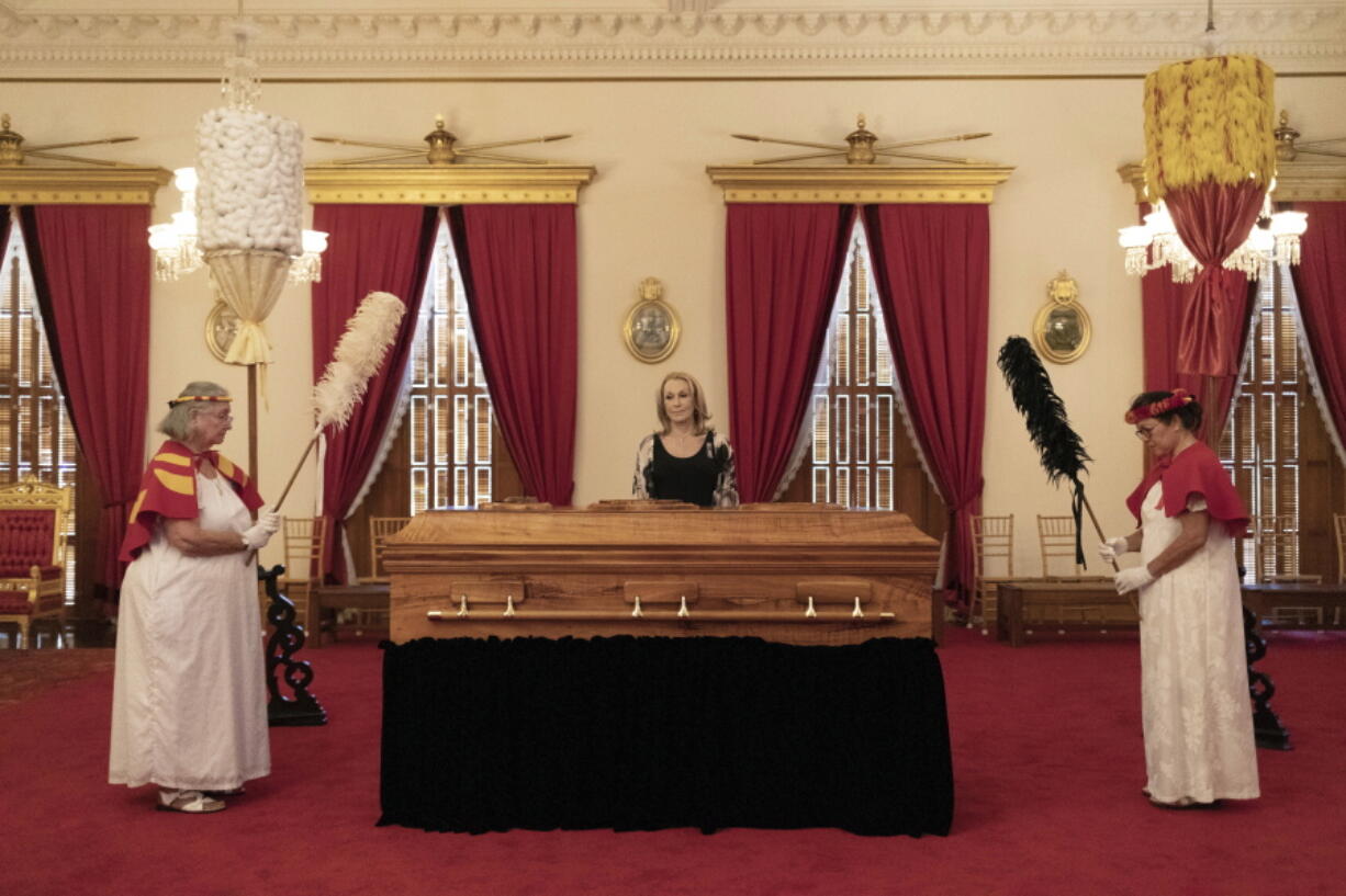 Veronica Gail Kawananakoa, center, wife of Abigail Kinoiki Kekaulike Kawananakoa, stands by her wife's casket during a public memorial at 'Iolani Palace, Sunday, Jan. 22, 2023, in Honolulu. The Campbell estate heiress with royal lineage died on Dec. 11, 2022, at the age of 96. Also pictured are members of the Hawaiian Royal Society Hale O Na Ali'i, which Kawananakoa was a member of.