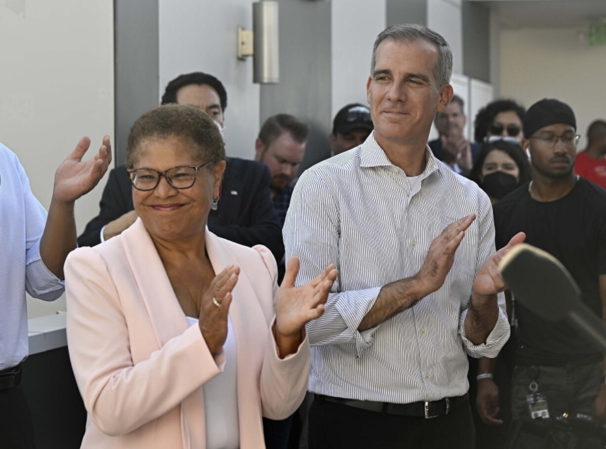 FILE - Los Angeles Mayor Eric Garcetti along with U.S. Rep. Karen Bass visit a Homekey site along Pico Boulevard as he announces awards for homeless housing projects across the state in Los Angeles on Wednesday, Aug. 24, 2022. Karen Bass, the first Black woman elected Los Angeles mayor, will be sworn-in as the 43rd Mayor of Los Angeles by Vice President Kamala Harris in an historic ceremony on Sunday, Dec. 11.