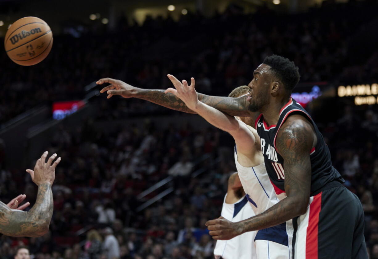 Portland Trail Blazers forward Nassir Little (10) knocks the ball away from Dallas Mavericks forward Davis Bertans during the first half of an NBA basketball game in Portland, Ore., Sunday, Jan. 15, 2023.