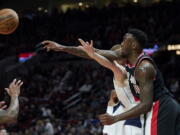 Portland Trail Blazers forward Nassir Little (10) knocks the ball away from Dallas Mavericks forward Davis Bertans during the first half of an NBA basketball game in Portland, Ore., Sunday, Jan. 15, 2023.