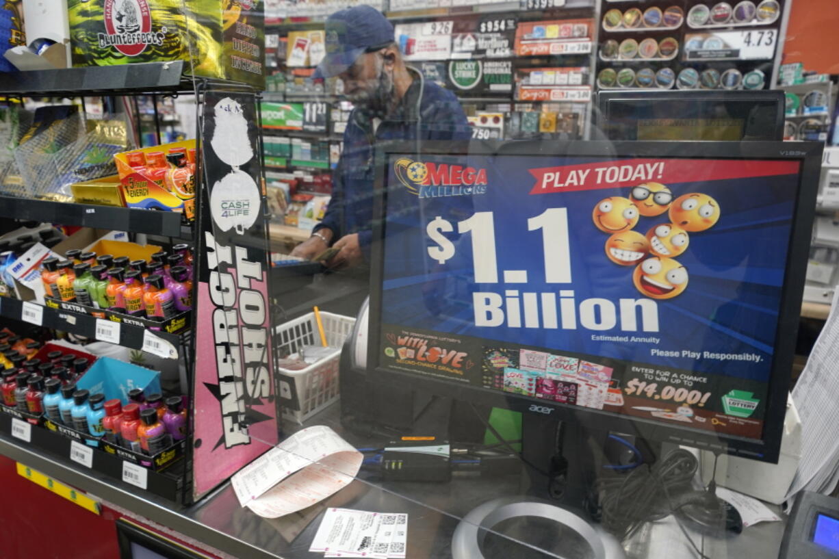 A Mega Million sign displays the estimated jackpot of $1.1 Billion at the Fuel On Convenience store in Pittsburgh, Monday, Jan. 9, 2023. The drawing Tuesday night is the fifth-largest ever.  (AP Photo/Gene J.