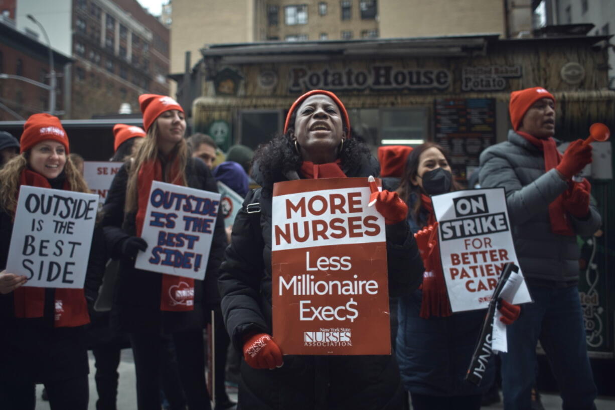 FILE - Nurses shout slogans and hold signs during a nursing strike outside Mount Sinai Hospital on Tuesday, Jan. 10, 2023, in New York. Two New York City hospitals have reached a tentative contract agreement with thousands of striking nurses that ends the walkout, the nurses' union announced Thursday, Jan. 12, 2023.