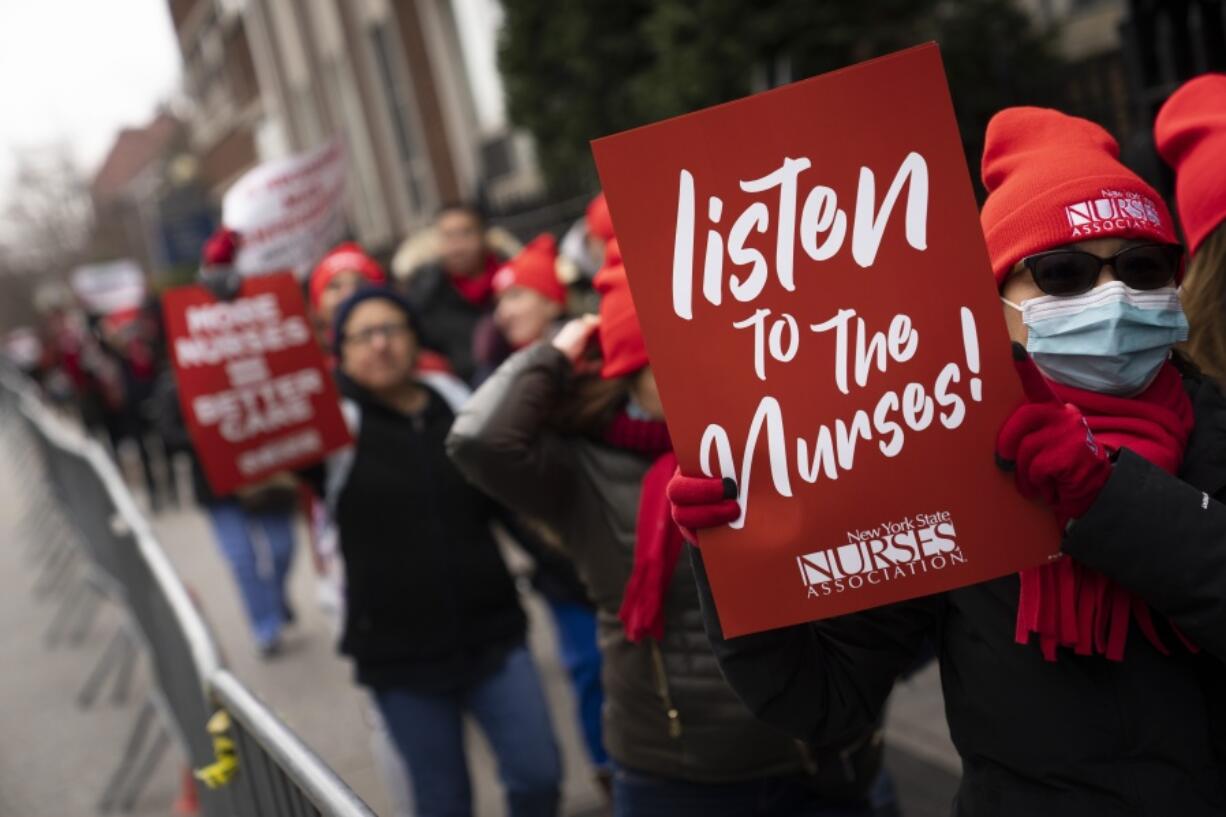 Protestors march on the streets around Montefiore Medical Center during a nursing strike, Wednesday, Jan. 11, 2023, in the Bronx borough of New York. A nursing strike that has disrupted patient care at two of New York City's largest hospitals has entered its third day.