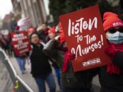 Protestors march on the streets around Montefiore Medical Center during a nursing strike, Wednesday, Jan. 11, 2023, in the Bronx borough of New York. A nursing strike that has disrupted patient care at two of New York City's largest hospitals has entered its third day.