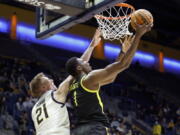 Oregon center N'Faly Dante (1) shoots against California forward Lars Thiemann (21) during the first half of an NCAA college basketball game in Berkeley, Calif., Wednesday, Jan. 18, 2023.