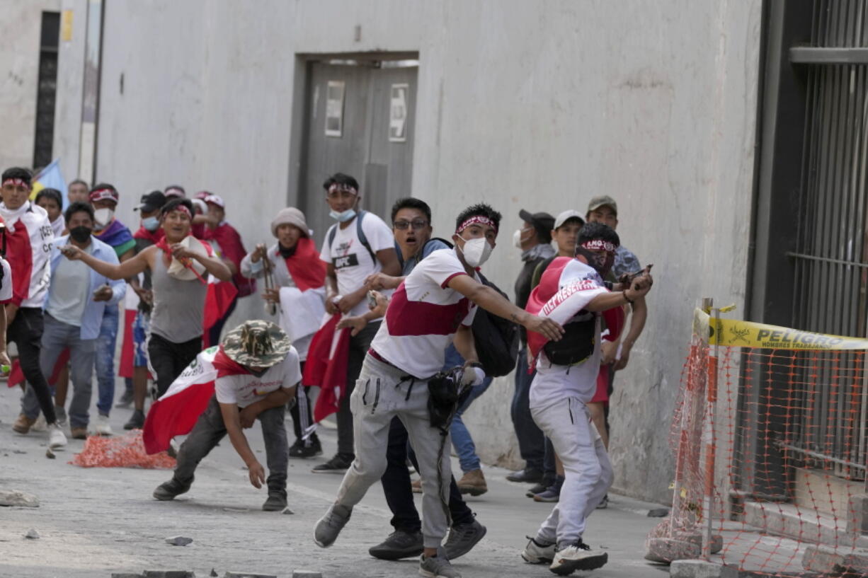 Anti-government protesters who traveled to the capital from across the country to march against Peruvian President Dina Boluarte, clash with the police in Lima, Peru, Thursday, Jan. 19, 2023. Protesters are seeking immediate elections, Boluarte's resignation, the release of ousted President Pedro Castillo and justice for the dozens of protesters killed in clashes with police.