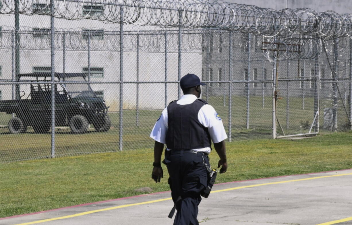 FILE - Prison staff work at Lee Correctional Institution, in Bishopville, S.C.. April 10, 2019. Top state prosecutors are urging Congress to pass legislation allowing state prisons to jam the signals of cellphones smuggled to inmates behind bars. The 22 attorneys general say Wednesday in a letter to House Speaker Kevin McCarthy and Senate Majority Leader Chuck Schumer that the devices allow prisoners to plot violence and carry out crimes.