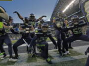 The Seattle Seahawks celebrate after an interception by safety Quandre Diggs during overtime of an NFL football game against the Los Angeles Rams Sunday, Jan. 8, 2023, in Seattle.